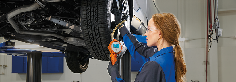 A Subaru technician checking tire pressure. | Jim Keras Subaru Hacks Cross in Memphis TN