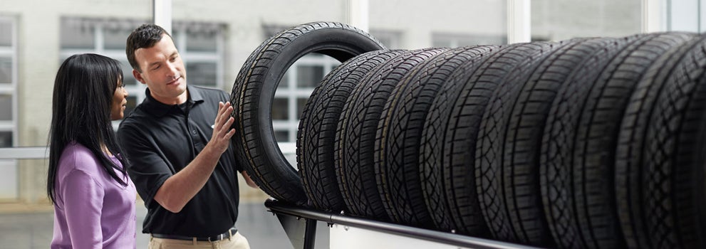 Subaru service representative showing customer a tire. | Jim Keras Subaru Hacks Cross in Memphis TN