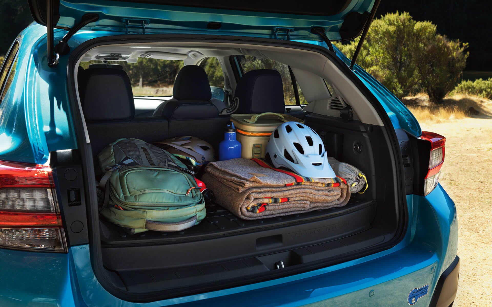 A backpack, blanket, and bike helmet in the rear cargo area of a Crosstrek Hybrid | Jim Keras Subaru Hacks Cross in Memphis TN