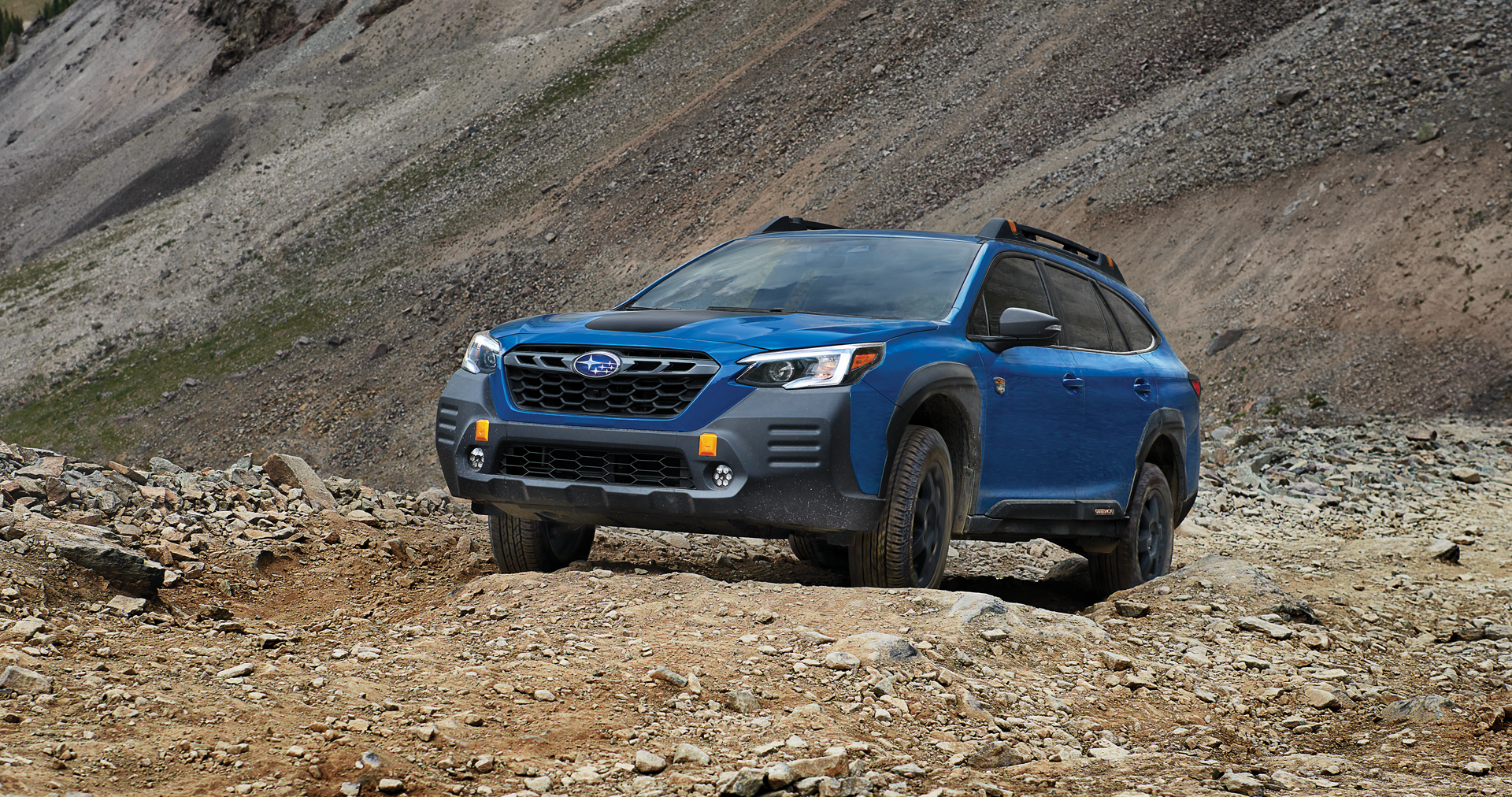 A 2023 Outback Wilderness driving on a trail in the mountains. | Jim Keras Subaru Hacks Cross in Memphis TN